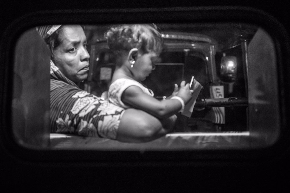 Where is he ... we wanna get home ... (Leica Q) Taken through the plastic back window of a tuc-tuc at night. 
